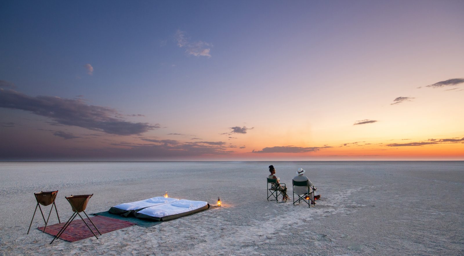 Two people sleeping out in the Salt Pans in Botswana