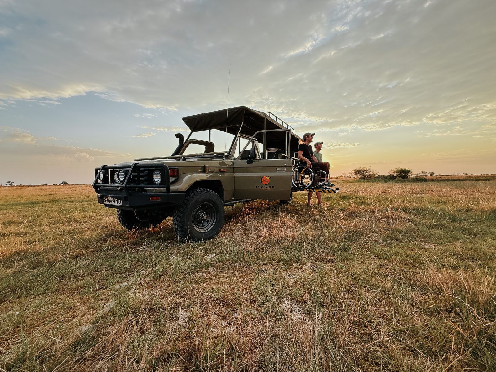 Sophie Morgan and Jonny May look out over the sunset in Botswana from a wheelchair accessible safari vehicle