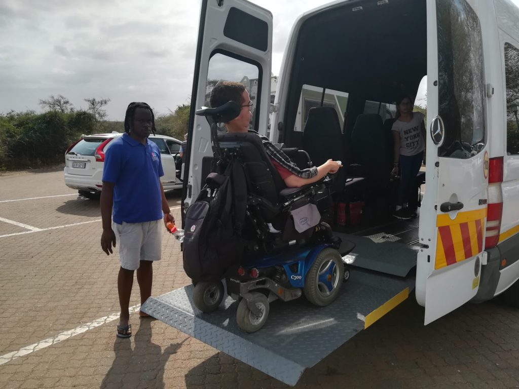 image of a wheelchair user on a ramp to an accessible vehicle